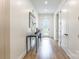 Hallway features a decorative table, white walls, wood-look floors, and recessed lighting at 7728 Shalom Dr, Charlotte, NC 28216