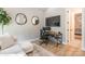 Cozy home office area featuring a desk, television, and comfortable sofa, perfect for a productive workspace at 7728 Shalom Dr, Charlotte, NC 28216