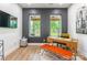 Bright home office with modern desk, stylish seating, and large windows overlooking the backyard at 7728 Shalom Dr, Charlotte, NC 28216