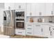 Modern kitchen with stainless steel appliances, white cabinets, quartz countertops, and a subway tile backsplash at 7728 Shalom Dr, Charlotte, NC 28216