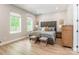 Serene main bedroom with natural light, a plush upholstered headboard, and neutral decor at 7728 Shalom Dr, Charlotte, NC 28216