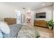 Bright main bedroom features hardwood floors, two dressers and access to an en-suite bathroom and main living area at 7728 Shalom Dr, Charlotte, NC 28216