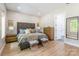 A comfortable main bedroom with a large bed, soft lighting, and easy access to the ensuite bathroom at 7728 Shalom Dr, Charlotte, NC 28216
