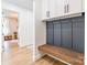 Stylish mudroom with bench, cabinets, and coat hooks, providing functional organization and storage at 7728 Shalom Dr, Charlotte, NC 28216