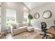 Home office featuring neutral walls, lots of natural light, and a sleek work space with black rolling chair at 7728 Shalom Dr, Charlotte, NC 28216