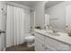 This bathroom features a shower and tub combo, tile floors, and white cabinets at 8037 Lynwood Sq, Waxhaw, NC 28173