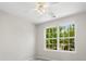 Bedroom features plush carpeting and a large window with mature trees visible at 8037 Lynwood Sq, Waxhaw, NC 28173