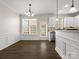 Bright dining area with wainscoting, modern lighting, and access to kitchen at 8037 Lynwood Sq, Waxhaw, NC 28173