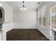 Dining room with dark wood floors, decorative molding, and lots of natural light at 8037 Lynwood Sq, Waxhaw, NC 28173