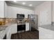 Modern kitchen featuring white cabinets, stainless steel appliances, and granite countertops at 8037 Lynwood Sq, Waxhaw, NC 28173