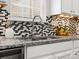 Close-up of the kitchen sink and countertop with stylish backsplash and stainless steel faucet at 8037 Lynwood Sq, Waxhaw, NC 28173