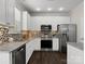 Bright kitchen with white cabinets, stainless steel appliances, and stylish backsplash at 8037 Lynwood Sq, Waxhaw, NC 28173