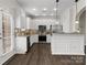 Modern kitchen featuring white cabinets, stainless steel appliances, and granite countertops at 8037 Lynwood Sq, Waxhaw, NC 28173
