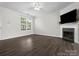 Spacious living room featuring a fireplace, ceiling fan, and ample natural light at 8037 Lynwood Sq, Waxhaw, NC 28173