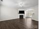 Bright and open living room showcasing a fireplace and view into the kitchen at 8037 Lynwood Sq, Waxhaw, NC 28173