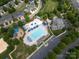 Aerial view of community pool with many lounge chairs and umbrellas, set within a neighborhood of attractive townhomes at 8317 Dallas Bay Rd, Charlotte, NC 28278