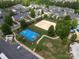Aerial view of community sports courts including tennis, volleyball, and basketball near well-maintained townhomes at 8317 Dallas Bay Rd, Charlotte, NC 28278