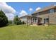 Large private backyard with patio, ideal for outdoor dining and entertaining with beautiful landscaping and ample space at 8317 Dallas Bay Rd, Charlotte, NC 28278