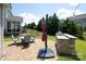 Outdoor patio with brick pavers, backyard kitchen and built-in grill perfect for entertaining or relaxing in the lush green space at 8317 Dallas Bay Rd, Charlotte, NC 28278