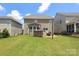 Large private backyard with patio, ideal for outdoor dining and entertaining with beautiful landscaping and ample space at 8317 Dallas Bay Rd, Charlotte, NC 28278