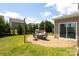 Enjoy outdoor living on this patio with a built-in grill, seating area, and string lights at 8317 Dallas Bay Rd, Charlotte, NC 28278