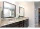 Dual sink bathroom with granite countertops, tiled floors, and dark wood cabinets at 8317 Dallas Bay Rd, Charlotte, NC 28278