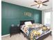 This cozy bedroom features a dark green accent wall with board and batten, a ceiling fan, and a large window at 8317 Dallas Bay Rd, Charlotte, NC 28278