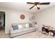 Neutral-toned room with ceiling fan, sofa with pillows, and toys and decorations at 8317 Dallas Bay Rd, Charlotte, NC 28278