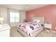 Bright bedroom with window, bed, and pink color scheme at 8317 Dallas Bay Rd, Charlotte, NC 28278
