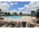 Community pool area featuring a large pool, comfortable lounge chairs, and shade for a perfect summer experience at 8317 Dallas Bay Rd, Charlotte, NC 28278