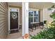 Inviting front porch with seating area, decorative wreath, and welcoming decor at 8317 Dallas Bay Rd, Charlotte, NC 28278