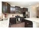 Stylish kitchen featuring stainless steel appliances, granite countertops, and dark wood cabinets at 8317 Dallas Bay Rd, Charlotte, NC 28278