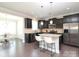 Modern kitchen with granite countertops, stainless steel appliances, and a breakfast bar at 8317 Dallas Bay Rd, Charlotte, NC 28278