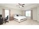 A spacious main bedroom with a tray ceiling, a large bed, and two windows at 8317 Dallas Bay Rd, Charlotte, NC 28278