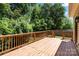 Wooden back deck featuring wood railing overlooking lush green backyard; an ideal space for outdoor relaxation at 8347 Fox Swamp Rd, Charlotte, NC 28215