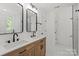 Modern bathroom featuring double vanity, hardwood cabinets, black hardware, and white tiled floors at 8347 Fox Swamp Rd, Charlotte, NC 28215