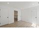Well-lit bedroom with white walls and hardwood floors leading to a bright hallway at 8347 Fox Swamp Rd, Charlotte, NC 28215