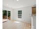 Bright dining area with sliding doors leading to a deck and a large window at 8347 Fox Swamp Rd, Charlotte, NC 28215