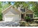 Charming home featuring a well-manicured lawn, attached garage, and traditional architectural details at 8347 Fox Swamp Rd, Charlotte, NC 28215