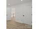 Bright, white hallway with hardwood floors and doors leading to other rooms at 8347 Fox Swamp Rd, Charlotte, NC 28215