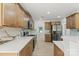 Modern kitchen with stainless steel appliances, marble backsplash, light hardwood flooring, and quartz countertops at 8347 Fox Swamp Rd, Charlotte, NC 28215