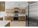 Modern kitchen featuring stainless steel appliances, granite countertops, and wood cabinets at 8347 Fox Swamp Rd, Charlotte, NC 28215