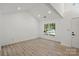 Bright, airy living room with wood floors and a large window offering a pleasant view at 8347 Fox Swamp Rd, Charlotte, NC 28215