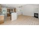 Open-concept living area with fireplace, stairs, bar, and wood floors at 8347 Fox Swamp Rd, Charlotte, NC 28215
