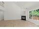 Spacious living room featuring a fireplace, wood floors, and large window at 8347 Fox Swamp Rd, Charlotte, NC 28215