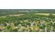 Aerial view of a property nestled in a lush neighborhood with mature trees at 908 Dairy Meadow Ct, Monroe, NC 28110