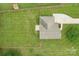 Aerial view of the property showcasing the home's roof, driveway, and spacious, fully fenced backyard at 908 Dairy Meadow Ct, Monroe, NC 28110
