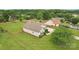 Aerial view of house with well-manicured lawn, fenced backyard, mature trees, and a paved driveway at 908 Dairy Meadow Ct, Monroe, NC 28110