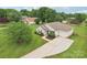 Beautiful aerial view of a well-maintained home, showcasing its large driveway and mature landscaping at 908 Dairy Meadow Ct, Monroe, NC 28110