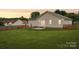 Expansive backyard featuring lush green grass, fenced-in area, and a cozy patio perfect for outdoor gatherings at 908 Dairy Meadow Ct, Monroe, NC 28110
